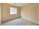 Bright bedroom features carpet, a window with blinds, and light beige walls for a serene atmosphere at 9324 Freedom Heights Ave, Las Vegas, NV 89149