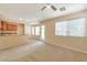Open-concept living room and kitchen featuring a breakfast bar and a view of the backyard at 9324 Freedom Heights Ave, Las Vegas, NV 89149