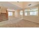 Open-concept living area featuring carpet flooring, neutral walls, and staircase to the second floor at 9324 Freedom Heights Ave, Las Vegas, NV 89149