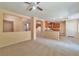 Open-concept living area with views of the kitchen, carpet flooring, and archways at 9324 Freedom Heights Ave, Las Vegas, NV 89149