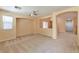 Expansive living area with carpet flooring, ceiling fan, and archways leading to other rooms at 9324 Freedom Heights Ave, Las Vegas, NV 89149