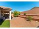 Charming backyard with cozy covered patio, terraced landscape, and low-maintenance desert plants at 10742 Cowlite Ave, Las Vegas, NV 89166