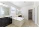 A bright bathroom with dual sinks, a soaking tub, and a separate glass shower at 10742 Cowlite Ave, Las Vegas, NV 89166