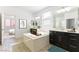 Bright bathroom features a soaking tub, double vanities, and tile floors at 10742 Cowlite Ave, Las Vegas, NV 89166