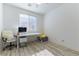 Bright bedroom with desk, computer, and light wood floor at 10742 Cowlite Ave, Las Vegas, NV 89166
