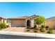 Charming single-story home with a well-manicured front yard and a brick driveway at 10742 Cowlite Ave, Las Vegas, NV 89166