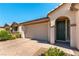 A single story home with a two-car garage and desert landscaping with a brick driveway at 10742 Cowlite Ave, Las Vegas, NV 89166