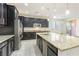 The gourmet kitchen boasts stainless steel appliances, dark wood cabinets, and a large island with a sink at 10742 Cowlite Ave, Las Vegas, NV 89166
