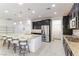 Bright eat-in kitchen with an island and seating, stainless steel appliances, and tile flooring at 10742 Cowlite Ave, Las Vegas, NV 89166