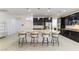 A spacious kitchen features dark wood cabinets, a large center island, and stainless steel appliances at 10742 Cowlite Ave, Las Vegas, NV 89166