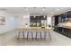 Spacious kitchen features dark cabinets, stainless steel appliances, and a large center island with seating at 10742 Cowlite Ave, Las Vegas, NV 89166