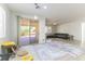 A sunny living room features a sliding door to a patio and seamlessly connects to the kitchen and dining areas at 10742 Cowlite Ave, Las Vegas, NV 89166