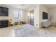A bright living room with tile floors and sliding glass doors to the patio, alongside a kitchen area at 10742 Cowlite Ave, Las Vegas, NV 89166