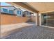 View of a fenced backyard showing brick pavers and dirt at 10851 Hanwicke Harbor Ave, Las Vegas, NV 89166