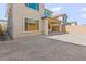 View of a fenced backyard with covered patio, exterior view of windows, and a dirt area at 10851 Hanwicke Harbor Ave, Las Vegas, NV 89166