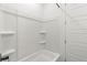 Clean, white bathroom featuring a tub/shower combo with built-in shelving at 10851 Hanwicke Harbor Ave, Las Vegas, NV 89166