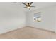 Well-lit bedroom with a large window, neutral carpet, and a ceiling fan at 10851 Hanwicke Harbor Ave, Las Vegas, NV 89166