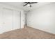 Bedroom features carpet, a ceiling fan, a closet, and an entry to another room at 10851 Hanwicke Harbor Ave, Las Vegas, NV 89166