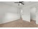 Neutral bedroom with plush carpeting, ceiling fan, and adjoining room at 10851 Hanwicke Harbor Ave, Las Vegas, NV 89166