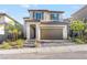Two story home featuring neutral colored exterior, red tile roof, and two car garage at 10851 Hanwicke Harbor Ave, Las Vegas, NV 89166