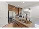 Kitchen island featuring stainless steel sink, granite counters, and stainless steel appliances at 10851 Hanwicke Harbor Ave, Las Vegas, NV 89166