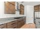 Modern kitchen with a gas cooktop, stainless steel appliances, granite countertops, and wood cabinets at 10851 Hanwicke Harbor Ave, Las Vegas, NV 89166