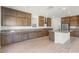 Gourmet kitchen featuring granite counters, stainless steel appliances, and wooden cabinets at 10851 Hanwicke Harbor Ave, Las Vegas, NV 89166