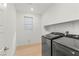 Well-lit laundry room with wood floors, modern appliances, and plenty of space at 10851 Hanwicke Harbor Ave, Las Vegas, NV 89166