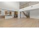 Large living room opening up to the kitchen with stainless appliances and modern finishes at 10851 Hanwicke Harbor Ave, Las Vegas, NV 89166