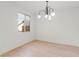 Bright living room featuring wood floors, a modern chandelier, and a sunlit window at 10851 Hanwicke Harbor Ave, Las Vegas, NV 89166