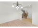 Open-concept living room with wood floors and view of carpeted stairs at 10851 Hanwicke Harbor Ave, Las Vegas, NV 89166