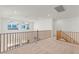 Bright loft area with neutral carpet, white walls, and natural light from the windows at 10851 Hanwicke Harbor Ave, Las Vegas, NV 89166