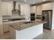 Modern kitchen featuring stainless steel appliances, granite countertops, and a central island at 11427 Ethereal Landing Ave, Las Vegas, NV 89138