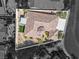 An aerial view showcases the home's unique architecture, landscaping, and outdoor living spaces in context with neighboring homes at 11621 La Mirago Pl, Las Vegas, NV 89138