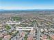 Wide aerial view of home in a community near North Tower Park with mountain views in the background at 11621 La Mirago Pl, Las Vegas, NV 89138