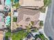 Stunning aerial view of a single Gathering home featuring desert landscaping, a covered patio and refreshing swimming pool at 11621 La Mirago Pl, Las Vegas, NV 89138