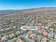 Expansive aerial view showcases home's location within a vibrant community near scenic mountains at 11621 La Mirago Pl, Las Vegas, NV 89138