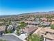 Expansive aerial shot showcasing the home's community, lush landscaping, and well-maintained neighborhood streets at 11621 La Mirago Pl, Las Vegas, NV 89138