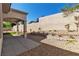 Back yard area featuring decorative rock landscaping, and a covered patio with columns at 11621 La Mirago Pl, Las Vegas, NV 89138