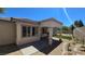 Covered patio and landscaped backyard with rock garden and small patch of green grass at 11621 La Mirago Pl, Las Vegas, NV 89138