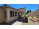 Covered patio and landscaped backyard with a rock garden at 11621 La Mirago Pl, Las Vegas, NV 89138