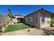 Backyard featuring artificial grass and desert landscaping at 11621 La Mirago Pl, Las Vegas, NV 89138