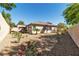 Charming single-story home featuring a xeriscaped backyard with decorative plants, shrubs, and colorful oleander at 11621 La Mirago Pl, Las Vegas, NV 89138