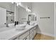 Bathroom featuring double vessel sinks, black hardware, and a glass enclosed shower at 11621 La Mirago Pl, Las Vegas, NV 89138