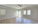 Spacious bedroom with wood floors, plantation shutters, and modern ceiling fan at 11621 La Mirago Pl, Las Vegas, NV 89138