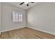 Bedroom features wood floors, neutral paint, ceiling fan, and white shutters at 11621 La Mirago Pl, Las Vegas, NV 89138