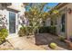 Front courtyard with low-maintenance desert landscaping, an outdoor sconce, and custom glass front door at 11621 La Mirago Pl, Las Vegas, NV 89138