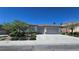 Attractive single-story home with a two-car garage and well-maintained landscaping at 11621 La Mirago Pl, Las Vegas, NV 89138