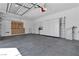 Spacious garage featuring storage cabinets, shelving, and epoxy flooring for organization and functionality at 11621 La Mirago Pl, Las Vegas, NV 89138