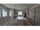 Modern kitchen with a center island, gray cabinets, quartz countertops, and stainless appliances at 11621 La Mirago Pl, Las Vegas, NV 89138